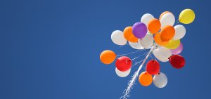 Balloons floating in a clear blue sky