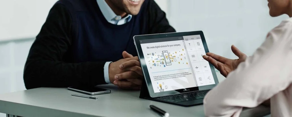 Company employees in meeting use Samsung / Android tablet for work