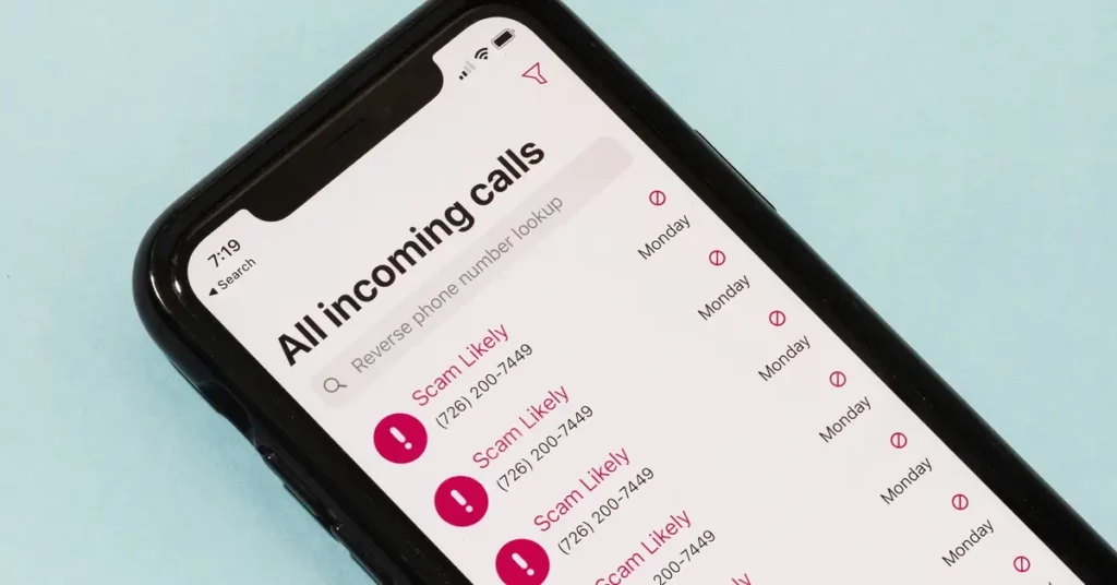 iPhone smartphone screen with recent incoming calls showing various Scam and Spam nuisance call numbers