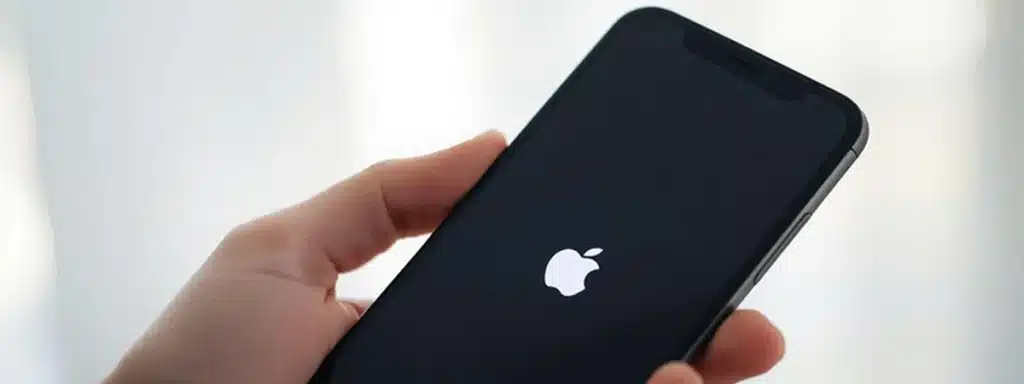 Man fixes a frozen iPhone by resetting it