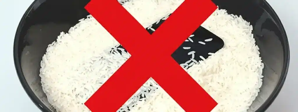 iPhone with water in a bowl of rice with a big red cross