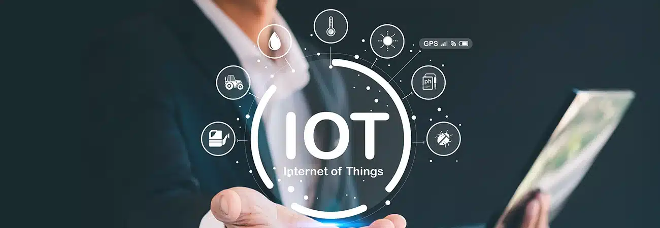 Business professional holding holographic IoT Internet of Things interface with smart device icons