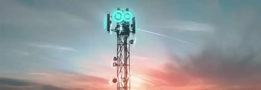 Mobile communication tower with glowing 6G network indicators against a dramatic sunset sky, symbolising network infrastructure.